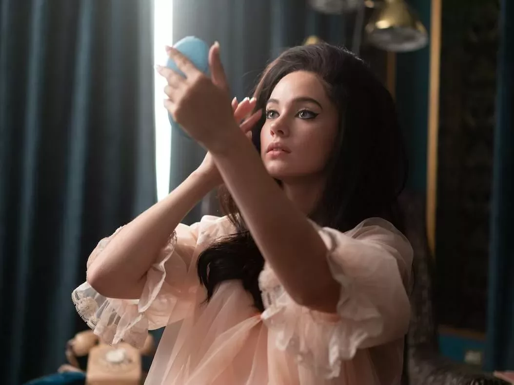a woman checking her makeup, scene from Priscilla (2023)